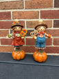 Set of two scarecrow on pumpkins