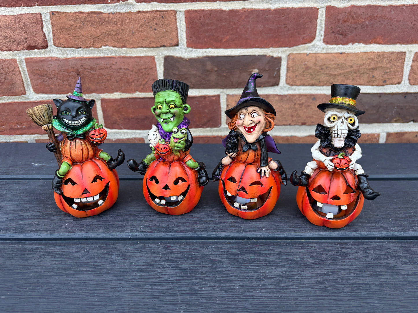 5.7" H set of 4  Halloween Figures on Pumpkins lights up! IN STOCK