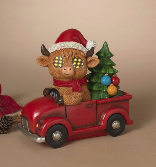 PREORDER ONLY 8.7"H B/O Lighted Resin Holiday Highland Cow in Truck w/ Moving Eyes & Timer